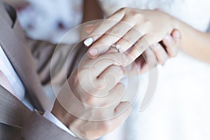 Close up hand groom couple put giving the Wedding Ring on bride.