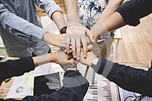 Close up ,Hand Group asia businessman together create a mutually beneficial business relationship. Economic graph on the table.