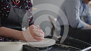 Close-up of the hand of a grumpy woman master works on a potter's wheel in slow motion. Making utensils with your own