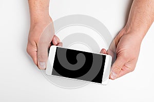 Close up hand hold phone isolated on white, mock-up smartphone white color blank screen