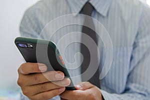 Close up hand holding businessman using mobile smart phone communicate online browse internet