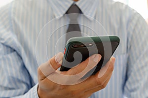Close up hand holding businessman using mobile smart phone communicate online browse internet