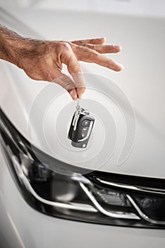 close up hand holding car keys. High quality photo