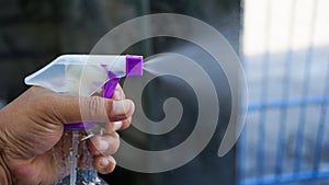 Close up of hand holding cleaning spray