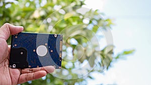 Close up of hand holding computer hard drive