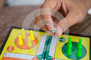Close up of hand holding dice while playing ludo