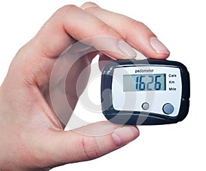 Close-up Of Hand Holding Digital Pedometer On