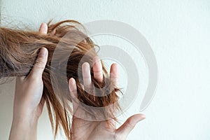 Close up hand holding dry damaged hair