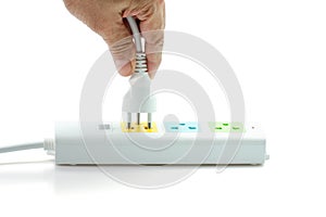 Close-up, Hand holding an electric plug ready to connect power strip on white background