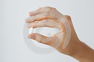 Close up of hand holding medicine pill