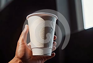 Close-up of a hand holding a paper cup with coffee, mockup illustration for design,