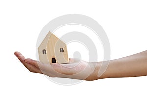 Close up hand holding wooden house model against on white background to show concept think for new house, plan for future