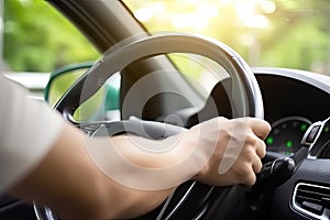 Close up hand holing or controlling steering wheel of car for driving, point of view inside car, on the highway road, with
