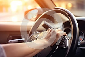 Close up hand holing or controlling steering wheel of car for driving, point of view inside car, on the highway road, with