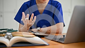 Close-up hand image of a focused male medical student or doctor joining a medical webinar