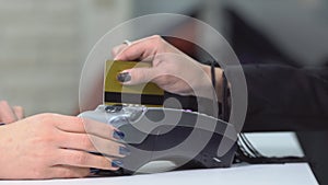 Close up of hand inserting bank card to terminal