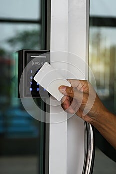 Close-up hand inserting keycard to lock and unlock door - Door access control keypad with keycard reader
