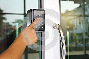 Close-up hand inserting keycard to lock and unlock door - Door access control keypad with keycard reader