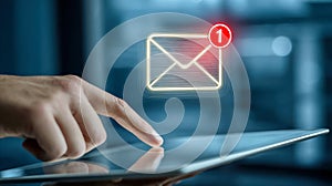 Close-up of hand interacting with digital tablet displaying new message notification icon representing modern communication and