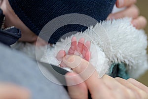 Close up of the hand of little baby holding mothers hand with his little fingers