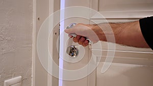 Close Up of Hand Locking the Door of House