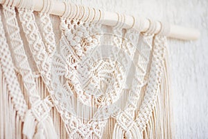 Close-up of hand made macrame texture pattern.  ECO friendly modern knitting DIY natural decoration concept  in the interior. Flat