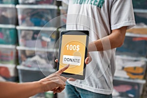 Close up of hand making donation by touching screen of tablet pc, Volunteers advertising or recommending app while