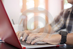 Close up of hand of male at finger typing keyboard of laptop of