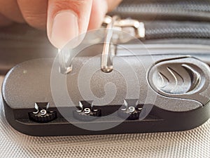 Close up hand man close suitcase with combination lock