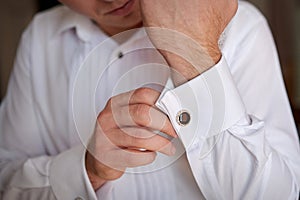 Close up of a hand man how wears white shirt and cufflink