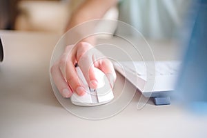 Close up hand man using mouse and computer at home with morning light