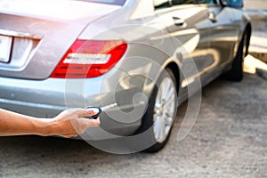 Close up hand man using remote for open car.transport,