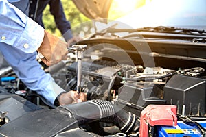 Close up hand of mechanic hands using wrench to repair a car engine.