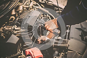 Close up hand of mechanic hands using wrench to repair a car engine.