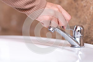 Close up hand open or close water tab . faucet and saving concept