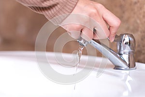 Close up hand open or close water tab . faucet and saving concept