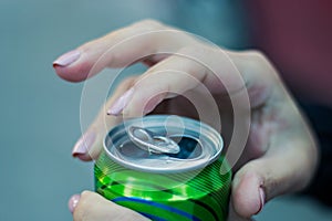 Close up of a hand opening a beverage