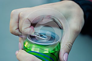 Close up of a hand opening a beverage