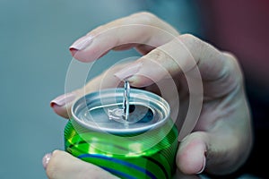 Close up of a hand opening a beverage