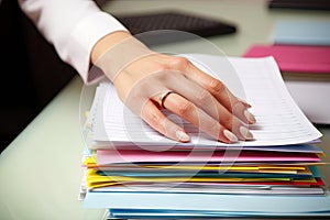 close-up of hand, organizing business documents in neat and orderly fashion