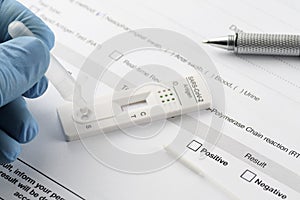 Close-up of hand performing a rapid antigen test for SARS-CoV-2, COVID-19