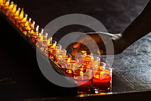 Close up of hand place red candle with wishes for making merit in Chinese temple, Chinese new year background concept