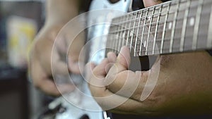 Close up hand playing electric guitar solo with speed picking technic