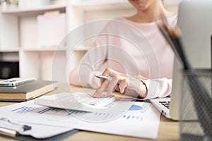 Close-up of hand pressing calculator to calculate income tax and company income in private office