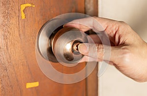 Close up of a hand pressing a door lock.