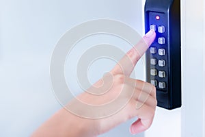 Close-up hand pressing keywords to lock and unlock door - Door access control keypad with keycard reader