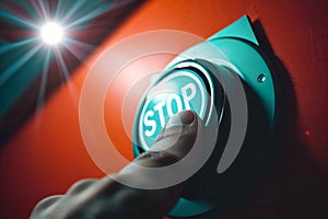 Close up of hand pressing stop button