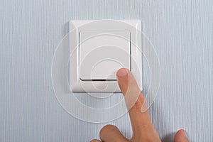 Close-up of hand pressing switch