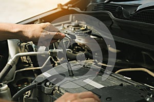 Close up of hand professional mechanic repairing a car in auto repair shop