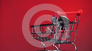 close-up hand puts car keys in shopping cart. New Car buying concept